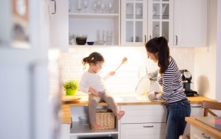 Family cooking in remodeled kitchen - 5 Kitchen Remodeling Tips for Your Forever Home